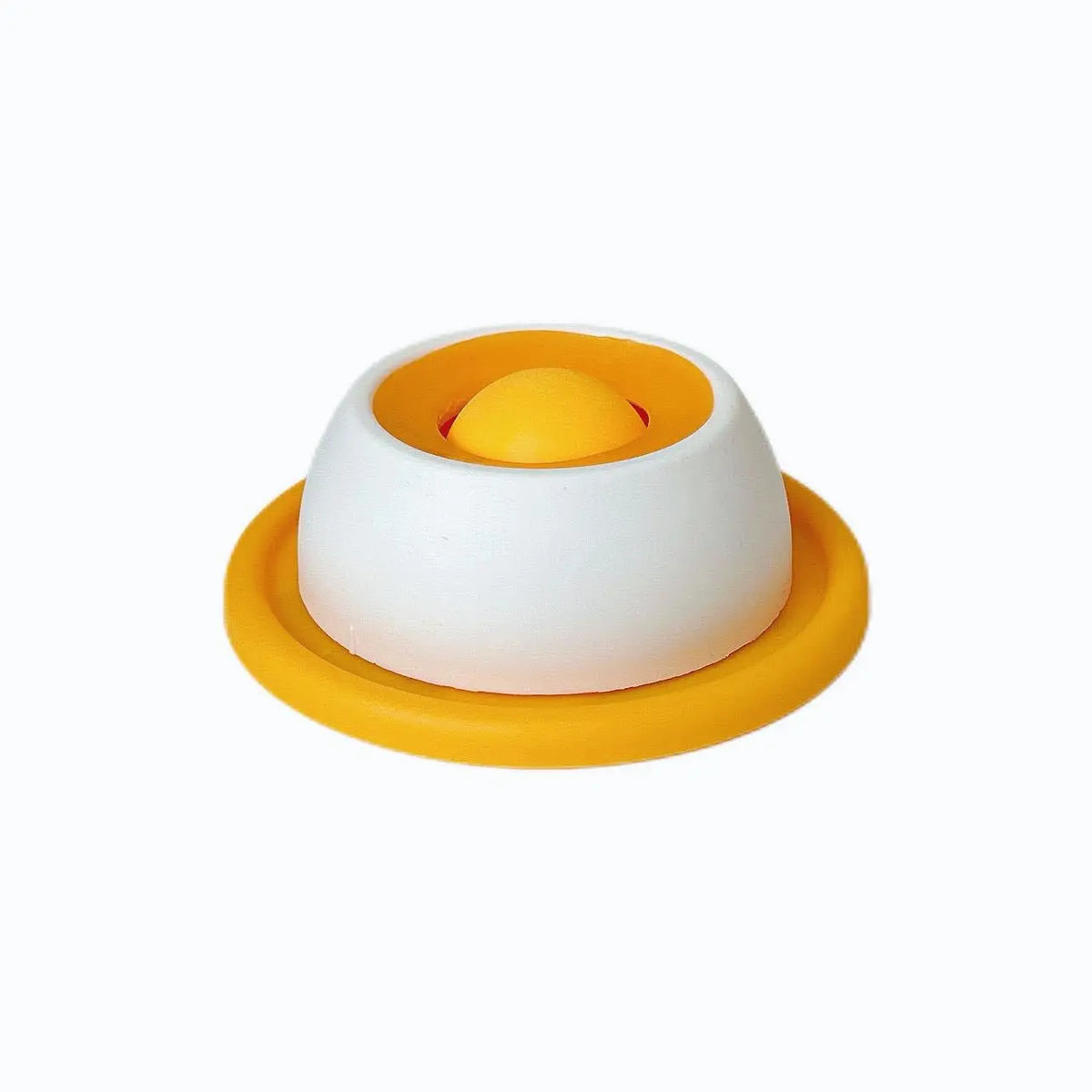 White treat bowl with yellow silicone base ring and yellow ball, angled view on a white background