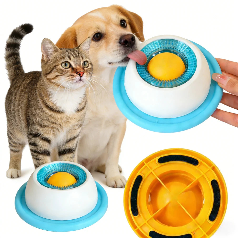 White treat bowl with blue base ring and yellow rolling ball, licked by a retriever puppy; tabby cat beside it