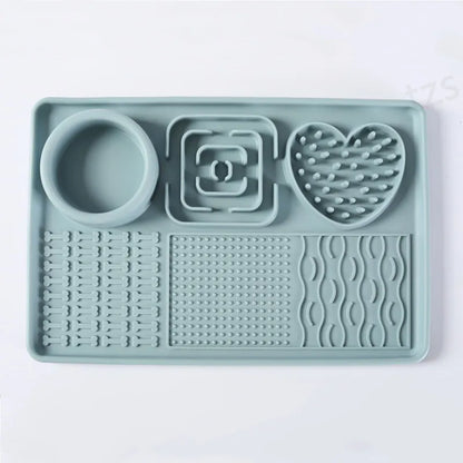 Sage green silicone lick mat from above: round bowl well, square and heart-shaped areas, three textured zones