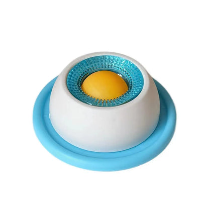White treat bowl with blue base ring, turquoise textured ring and yellow ball, angled view on white